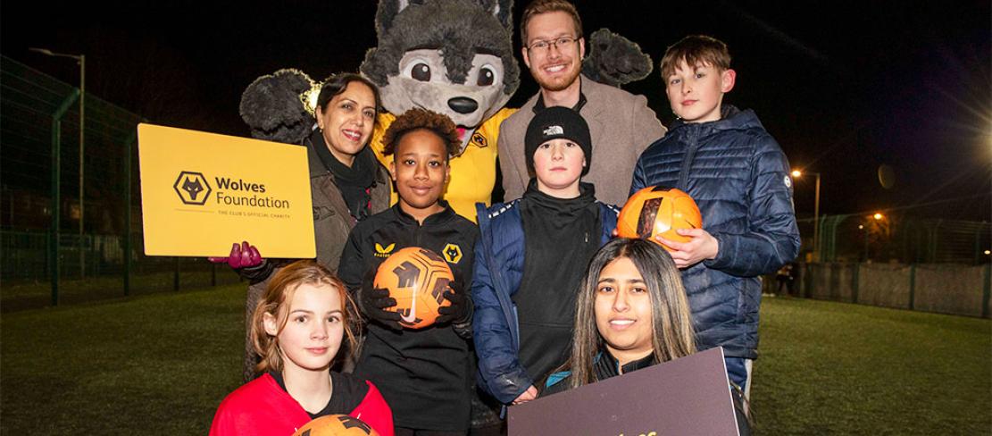 Councillor Jasbir Jaspal, Cabinet Member for Adults and Wellbeing, Councillor Christopher Burden, Cabinet Member for Children and Young People, Wolves Foundation Community and Cohesion Officer Nikki Lal and young people celebrate the launch of the new Yo! Active programme.
